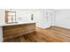 Bright, open kitchen with a wooden breakfast bar, modern sink and a new hardwood floor at 730 W Swoope Ave, Winter Park, FL 32789
