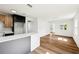 Bright kitchen with white walls, hardwood floors, stone counters, stainless steel appliances, and window at 730 W Swoope Ave, Winter Park, FL 32789