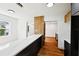 Kitchen with stone counter, hardwood floors, and wood accent divider near new appliances at 730 W Swoope Ave, Winter Park, FL 32789