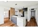 Spacious open floor plan with hardwood floors and a modern kitchen island with barstool seating at 730 W Swoope Ave, Winter Park, FL 32789
