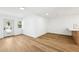 Modern living room featuring wood-look floors, white walls, modern lighting, and a view of the front yard at 730 W Swoope Ave, Winter Park, FL 32789
