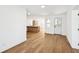 Open concept living area featuring wood floors, white walls, modern lighting, and seamless transition to the kitchen at 730 W Swoope Ave, Winter Park, FL 32789