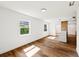 Living room featuring hardwood floors, white walls, and an open kitchen area with granite counter at 730 W Swoope Ave, Winter Park, FL 32789