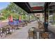 Charming outdoor café with tables and chairs under umbrellas, set along a tree-lined street with boutique shops at 730 W Swoope Ave, Winter Park, FL 32789
