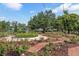 Beautiful rose garden featuring brick pathways, blooming roses, benches, and lush greenery in a park setting at 730 W Swoope Ave, Winter Park, FL 32789