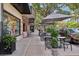 Outdoor seating area with cafe tables and umbrellas along a shopping street with upscale boutiques at 730 W Swoope Ave, Winter Park, FL 32789