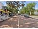 Picturesque street scene with outdoor cafes, lined with mature trees, parked cars, and charming buildings at 730 W Swoope Ave, Winter Park, FL 32789