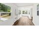 Bright sun room features wood floors, white walls and trim, and lots of windows with natural light at 730 W Swoope Ave, Winter Park, FL 32789