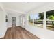 Bright sun room features wood floors, white walls and trim, and lots of windows with natural light at 730 W Swoope Ave, Winter Park, FL 32789