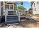 Charming back porch features wood stairs, white railings, perfect for enjoying the outdoors at 821 E Lemon Ave, Eustis, FL 32726