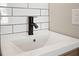 Bathroom sink with modern faucet and white subway tile backsplash at 821 E Lemon Ave, Eustis, FL 32726