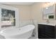 Bathroom features a freestanding tub, modern vanity, and a large window at 821 E Lemon Ave, Eustis, FL 32726