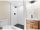 Modern bathroom with white subway tile shower, black accents, and wooden vanity at 821 E Lemon Ave, Eustis, FL 32726