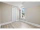 Bedroom featuring light wood floors, a large window, and a closet at 821 E Lemon Ave, Eustis, FL 32726