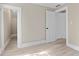 Bedroom with light wood floors and white doors leading to other rooms at 821 E Lemon Ave, Eustis, FL 32726
