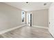 Bright, neutral bedroom with light wood floors, a window, and closet doors at 821 E Lemon Ave, Eustis, FL 32726