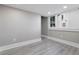 Bright bedroom features light gray wood floors, a window, and recessed lighting at 821 E Lemon Ave, Eustis, FL 32726