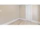 Bedroom with neutral walls, light wood floors, and a bi-fold closet at 821 E Lemon Ave, Eustis, FL 32726
