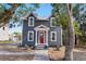 Charming two-story home with gray siding, a red door, and a well-manicured front yard at 821 E Lemon Ave, Eustis, FL 32726