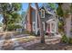 Two story home with gray siding, brick chimney, and mature trees at 821 E Lemon Ave, Eustis, FL 32726