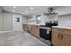 Updated kitchen featuring stainless steel appliances, custom cabinets, and quartz countertops at 821 E Lemon Ave, Eustis, FL 32726