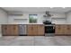 Updated kitchen featuring stainless steel appliances, custom cabinets, and quartz countertops at 821 E Lemon Ave, Eustis, FL 32726