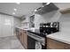 Updated kitchen featuring stainless steel appliances, custom cabinets, and quartz countertops at 821 E Lemon Ave, Eustis, FL 32726
