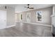 Spacious living room with wood floors, a modern fan, and a bright white door at 821 E Lemon Ave, Eustis, FL 32726