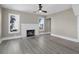 Bright living room with hardwood floors, white brick fireplace, and large windows at 821 E Lemon Ave, Eustis, FL 32726
