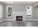 Bright living room with hardwood floors, white brick fireplace, and large windows at 821 E Lemon Ave, Eustis, FL 32726