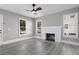 Bright living room with hardwood floors, white brick fireplace, and large windows at 821 E Lemon Ave, Eustis, FL 32726
