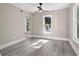 Cozy room with a modern ceiling fan, lots of windows, and wood-look floors at 821 E Lemon Ave, Eustis, FL 32726