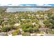 Aerial view showcasing lush landscaping and beautiful houses in a desirable community with a large lake nearby at 8316 Granada Blvd, Orlando, FL 32836