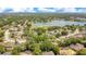 An aerial view of a residential area with tree-lined streets and a large lake adding to the scenery at 8316 Granada Blvd, Orlando, FL 32836