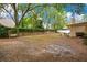 Large backyard with mature trees and brick fence; perfect for outdoor activities at 8316 Granada Blvd, Orlando, FL 32836