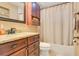 Bathroom featuring a shower and tub combination with dark wood cabinets at 8316 Granada Blvd, Orlando, FL 32836