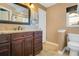 Granite vanity with warm neutral color palette, updated fixtures, and tiled floors at 8316 Granada Blvd, Orlando, FL 32836