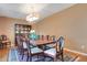 Dining room with a large table and chairs, hardwood floors, and a display cabinet at 8316 Granada Blvd, Orlando, FL 32836