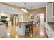 Bright kitchen with stainless steel appliances, a breakfast bar, and hardwood floors at 8316 Granada Blvd, Orlando, FL 32836