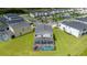 Aerial view showcasing the home, screened-in pool, and the surrounding community at 901 Ocean Course Ave, Davenport, FL 33896