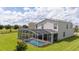 View of enclosed private backyard featuring covered patio, screened pool, and outdoor furniture at 901 Ocean Course Ave, Davenport, FL 33896