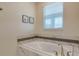 Inviting soaking tub with elegant fixtures and tilework, creating a peaceful spa-like atmosphere for relaxation at 901 Ocean Course Ave, Davenport, FL 33896