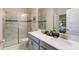 Bathroom featuring a glass enclosed shower, double vanity and neutral colors at 901 Ocean Course Ave, Davenport, FL 33896
