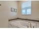 Soaking tub in primary bathroom featuring neutral colors and natural light at 901 Ocean Course Ave, Davenport, FL 33896