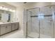 Bathroom featuring a glass enclosed shower, double vanity and neutral colors at 901 Ocean Course Ave, Davenport, FL 33896