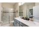 Modern bathroom featuring double sinks, a glass-enclosed shower, and stylish finishes for a luxurious feel at 901 Ocean Course Ave, Davenport, FL 33896
