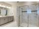 Bright bathroom featuring a glass shower, double vanity, and modern fixtures, offering a spa-like experience at 901 Ocean Course Ave, Davenport, FL 33896