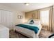 Cozy bedroom features a plush bed, neutral decor, and ample natural light from the window at 901 Ocean Course Ave, Davenport, FL 33896