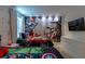 Themed bedroom featuring a custom wall mural, adding a playful and imaginative touch to the space at 901 Ocean Course Ave, Davenport, FL 33896
