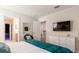 Bright bedroom boasts a TV, comfortable seating, and serene decor for relaxation and entertainment at 901 Ocean Course Ave, Davenport, FL 33896